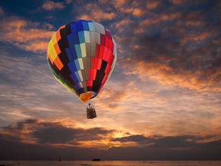 Fototapeta premium Hot air balloon over the sea at sunset