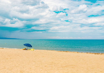 Sunshade beach sand shore sea ocean coast horizon summer storm cloud sky nobody