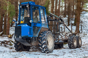 Fototapeta na wymiar Winter snow forest tree tractor machine indrustry equipment wood vehicle outdoor nobody