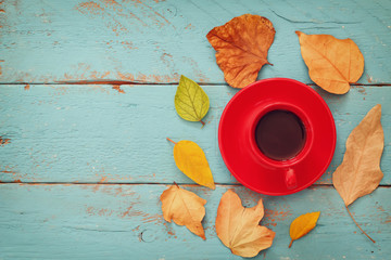 Fototapeta na wymiar Autumn background with dry leaves and cup of coffee