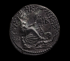 Ancient silver coin in black patina