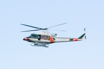 Fototapeta na wymiar White-orange helicopter is flying