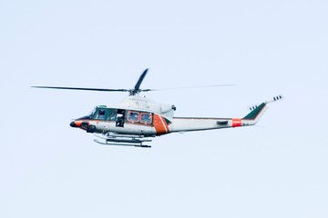 White-orange helicopter is flying