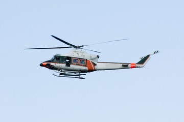 White-orange helicopter is flying