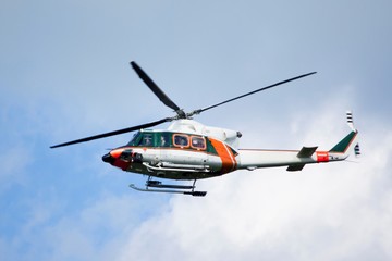 White-orange helicopter is flying