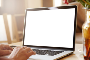 Female photographer or retoucher retouching photographs using laptop computer with blank copy space...