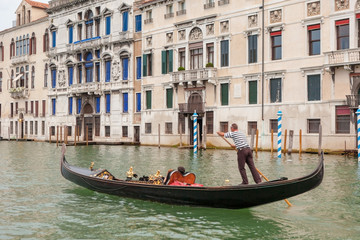 Fototapeta na wymiar Venetian gondolier on gondola