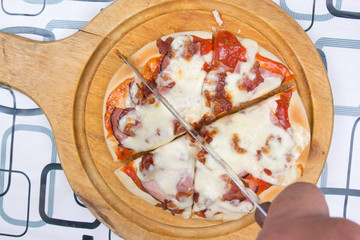 Chef cutting Pizza