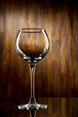 Empty wine glass on dark wooden background