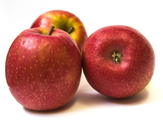 Three fresh red apples with drops isolated on white