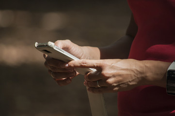 Woman using her smartphone and smartwatch