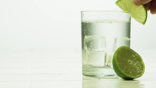 Slice of lime in a carbonated drink in a clear glass