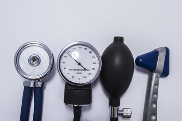 Set of stethoscope with diaphragm upwards, sphygmomanometer, air inflating bulb and neurological...