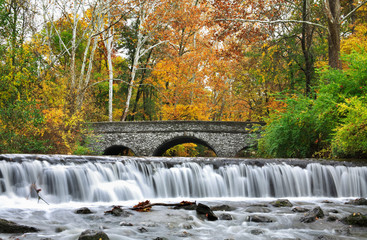 Fototapeta na wymiar Stone Bridge And Waterfall