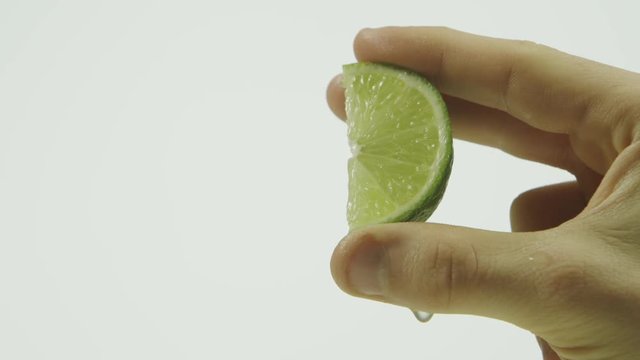 Closeup squeezing a slice of lime