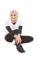 attractive muslim sporty woman sitting on the floor