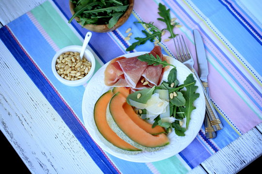 Salad with prosciutto, melon, arugula & pine nuts