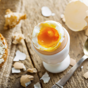 Breakfast with perfect soft boiled egg and sandwich with cheese. Traditional homemade food.