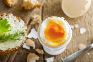 Perfect soft boiled egg with bread and butter for breakfast. Traditional healthy food. Top view.