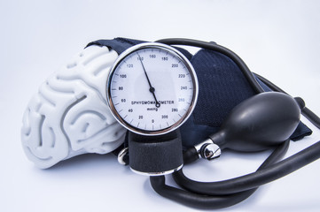 The figure of the human brain enveloped sphygmomanometer cuff with bulb (pear) and dial showing...