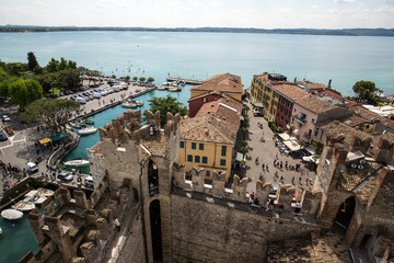 View of colorful old buildings in Sirmione and Lake Garda from Scaliger castle wall, Italy