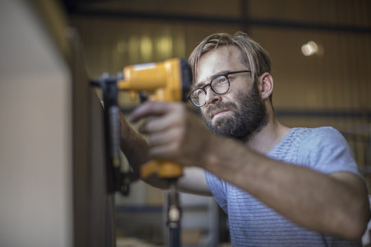 Carpenter using a staple gun