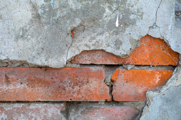 cracked, falled old red brick wall
