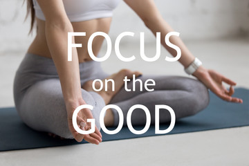 Beautiful young woman working out in loft interior, doing yoga exercise on blue mat, Sitting in...