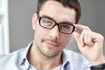 portrait of businessman in eyeglasses at office