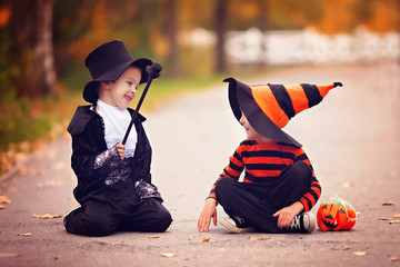 Two boys in the park with Halloween costumes