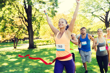 happy young female runner winning on race finish