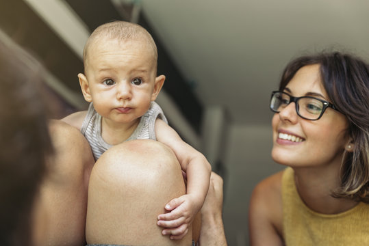 Unrecognizable father with baby on his knees