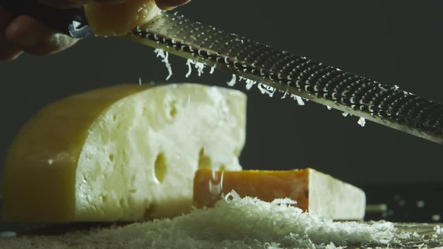 Slow motion shaving a block of cheese