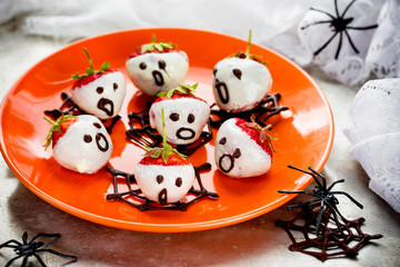 Halloween strawberries on orange plate