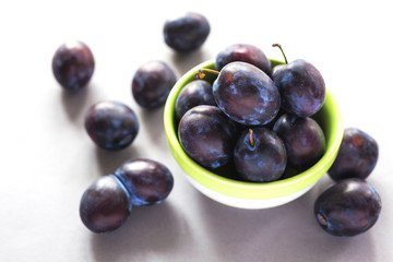 Sweet ripe plums on rustic background. Close-up.