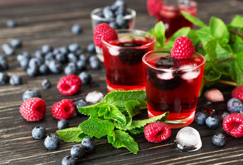 Fresh cocktail with blueberry, raspberry, mint and ice