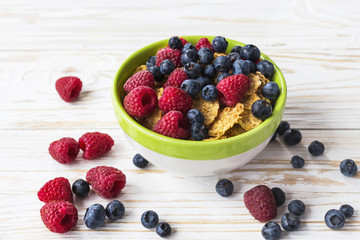 Healthy corn flakes breakfast on the white wooden table