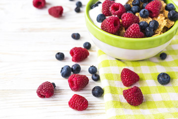 Healthy corn flakes breakfast on the white wooden table