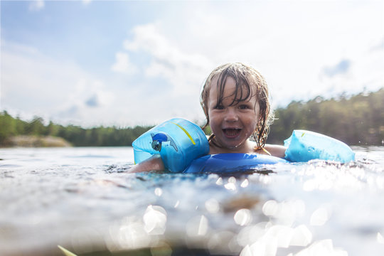 Laughing boy swimming