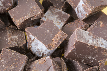 Chopped pile chocolate pieces background.