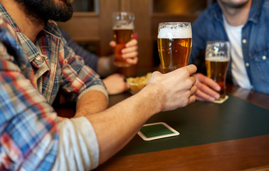 happy male friends drinking beer at bar or pub