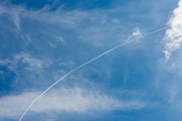 Fototapeta na wymiar Jet of airplane in the blue sky