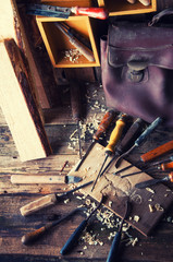 Naklejka premium Chisels and carved piece of wood in traditional carpenter workshop