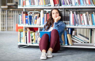 high school student girl reading book at library