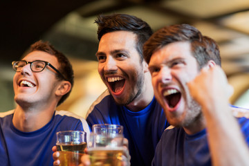 football fans or friends with beer at sport bar