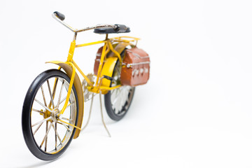Fototapeta na wymiar Shallow focus of a hand made yellow bicycle model isolated on wh