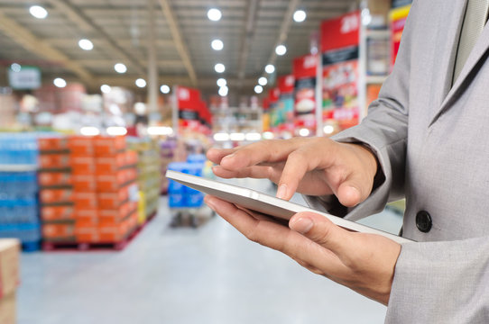 Hand of Businessman, Manger use Mobile Tablet in supermarket