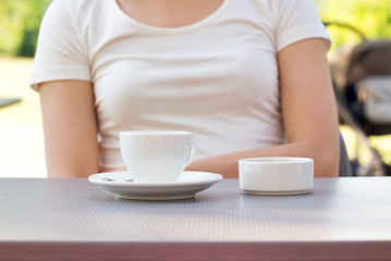 cup of coffee and sugar on a table, outdoor cafe in the park