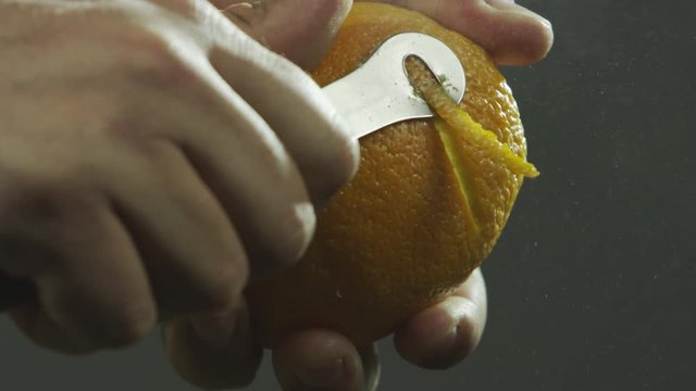 Slow motion peeling orange skin