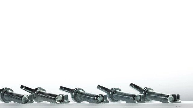 row of screw with caps wrenching on white background
